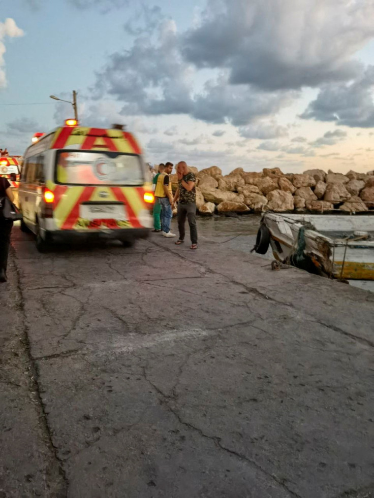 An ambulance is seen during the rescue process of migrants in the port of Tartous