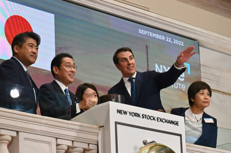 Japanese Prime Minister Fumio Kishida (2-L)  stands with John Tuttle (R), Vice Chairman of the NYSE Group, before ringing the closing bell at the New York Stock Exchange on September 22, 2022