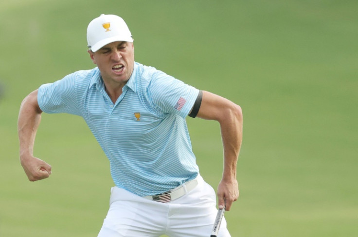 Justin Thomas of the United States Team reacts to making a long par putt on the 15th hole during a foursomes triumph at the Presidents Cup