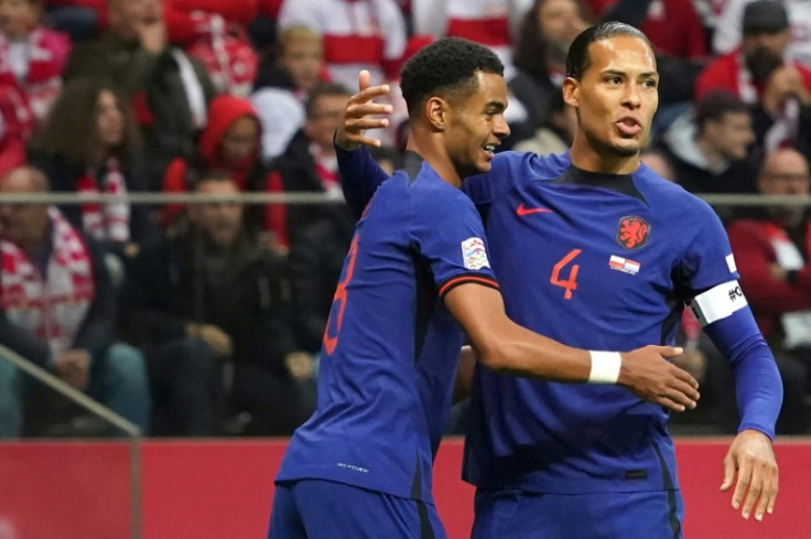 Cody Gakpo (L) is congratulated by Virgil van Dijk after putting the Netherlands ahead away in Poland