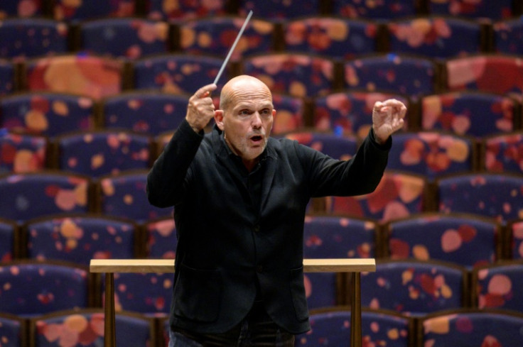Dutch conductor Jaap van Zweden leads a rehearsal at the New York Philharmonic's new hall, where musicians and acousticians are "tuning the space" in preparation for a grand opening
