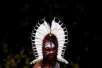 An indigenous man from the Torres Strait Islands wears a traditional dress as he performs during a welcoming ceremony at Government House in Sydney