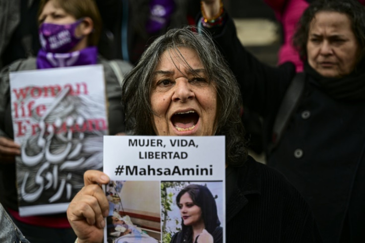 A woman holds a picture of Amini during a demonstration in Santiago, Chile
