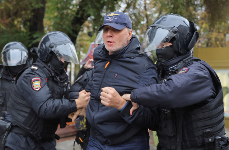 Russian police officers detain a person during a rally in Moscow