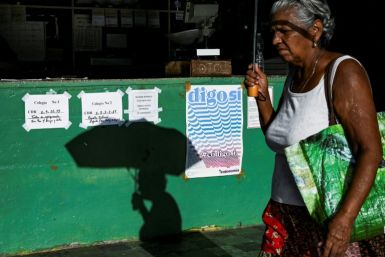 A woman walks past a sign in favor of the new family code in Havana ahead of Sunday's referendum