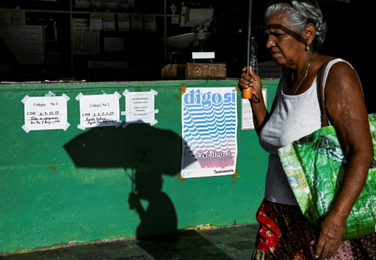 A woman walks past a sign in favor of the new family code in Havana ahead of Sunday's referendum