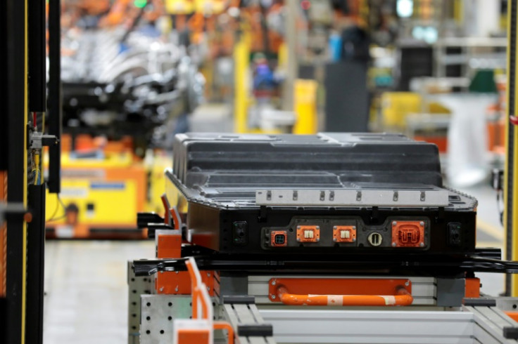 A battery waits to be installed on the frame of an electric-powered F-150 Lightning truck