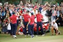 The United States team celebrates on the 18th green after Xander Schauffele sank the clinching putt to deliver a ninth consecutive victory in the Presidents Cup