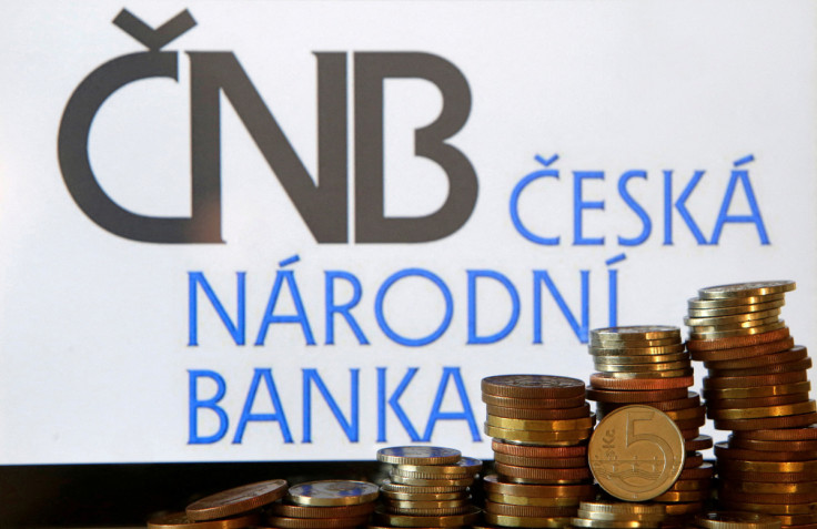 Czech Crown coins are seen in front of a displayed logo of Czech central bank (CNB) in this picture illustration