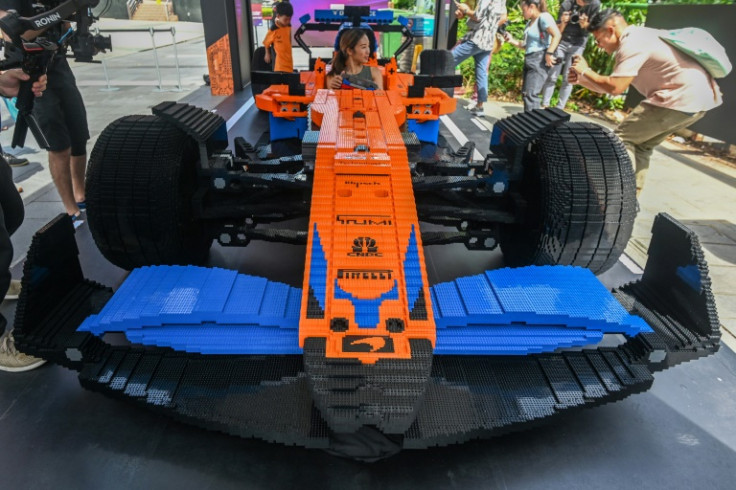 People take pictures of a life-sized LEGO F1 car in Singapore