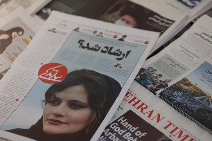 A newspaper with a cover picture of Mahsa Amini, a woman who died after being arrested by Iranian morality police, is seen in Tehran