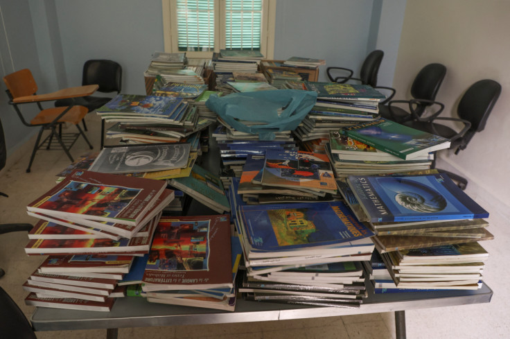 Piled up schoolbooks are placed on a table at a closed public school in Beirut