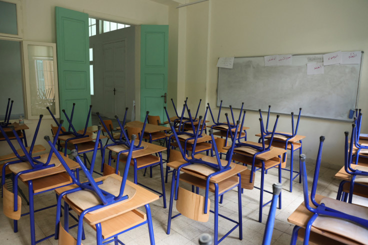 Chairs are placed on classroom tables at a closed public school in Beirut