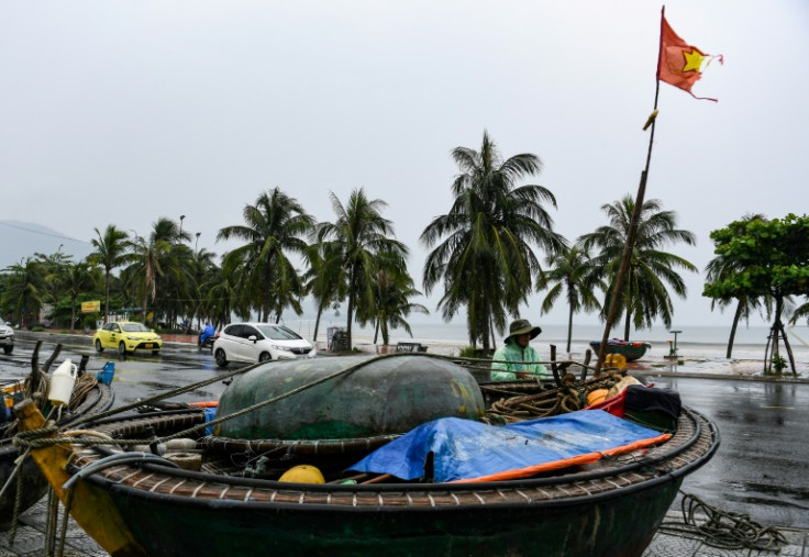 A fisherman ties his boat on a street to protect it from Typhoon Noru in Danang hours before the storm made landfall