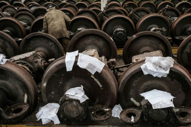 Workers at Kharkiv's rail yard laid wet documents dug from the rubble on train wheels to dry after the latest Russian missile strike