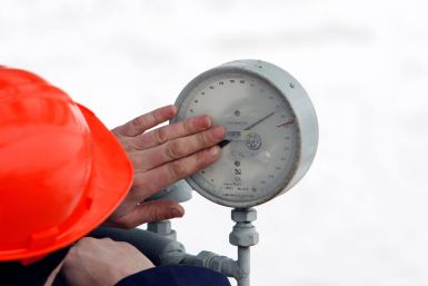 A Gazprom technician inspects a pressure gauge at the gas export monopoly's Sudzha compressor station