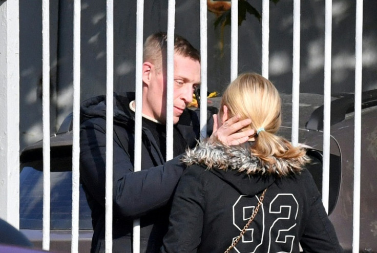 A young couple bid a final goodbye at a military recruitment centre in Saint Petersburg after Russia announced a draft of thousands of reservists