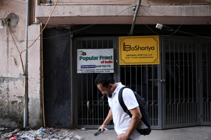 A man walks past the old office of Popular Front of India (PFI) Islamic group, in New Delhi