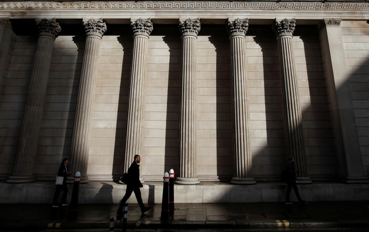 A commuter walks past the Bank of England, in London