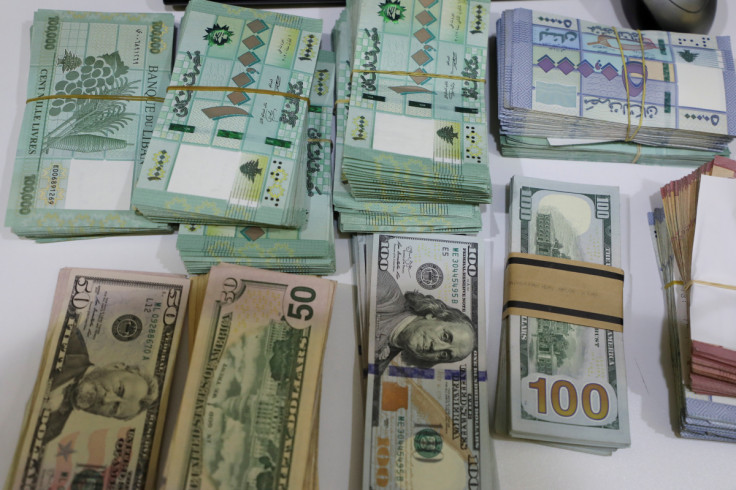 U.S. dollar banknotes and Lebanese pounds are pictured at a currency exchange shop in Beirut