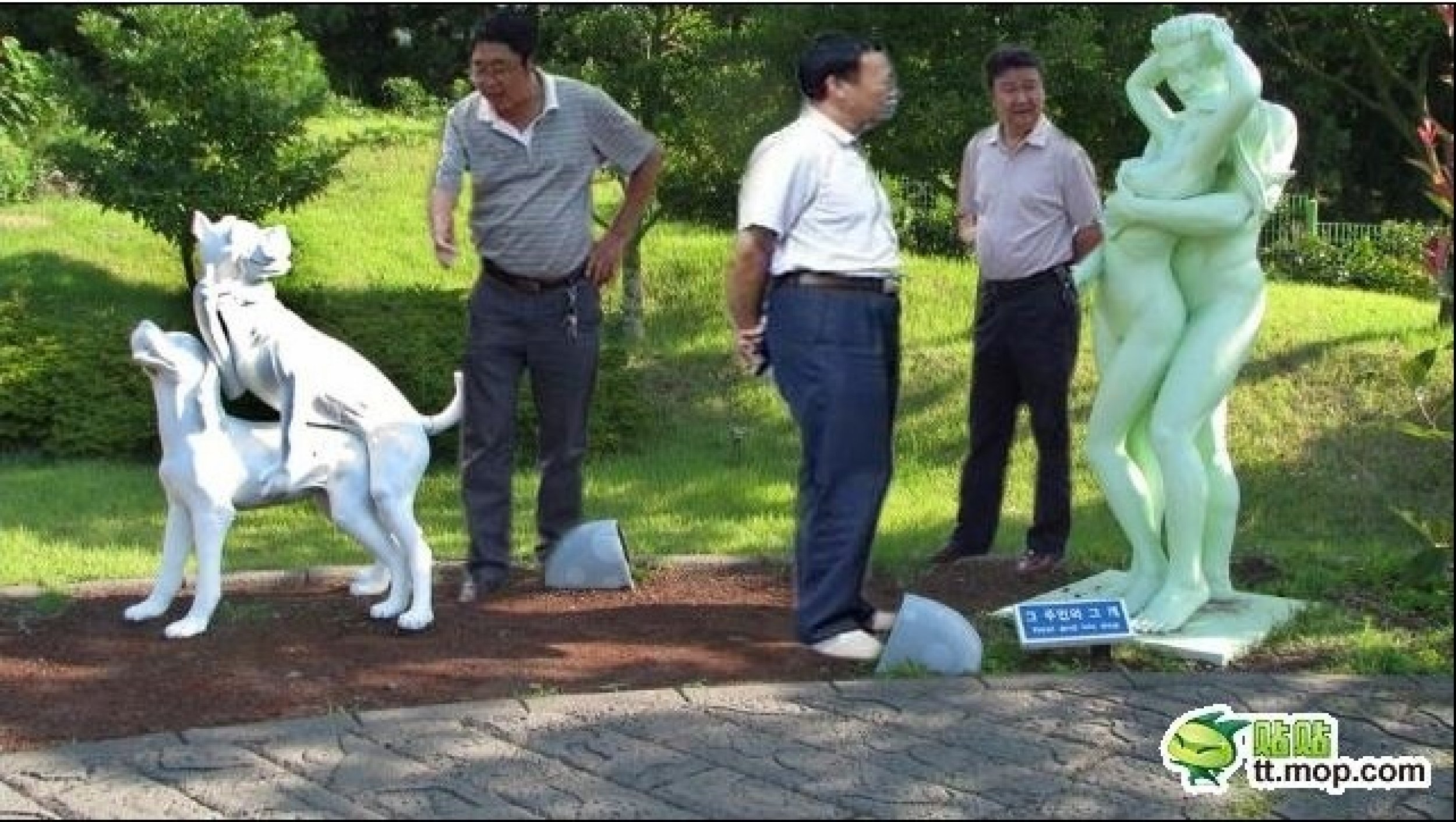 The 3 Chinese government officials appreciate the art work.