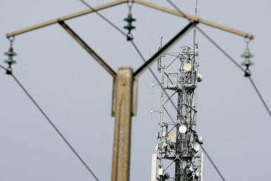 A mobile-phone relay mast is seen behind an electrical pylon in Tilloy-les-Cambrai