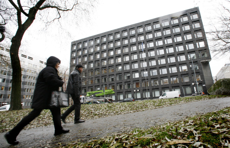 Pedestrians walk past Sweden's Riksbank building in downtown Stockholm