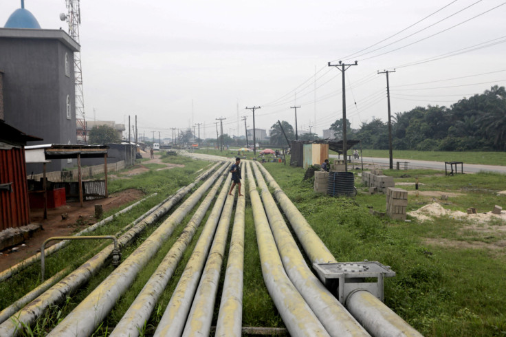 A woman walks over pipelines crisscrossing Ogoniland in Rivers State