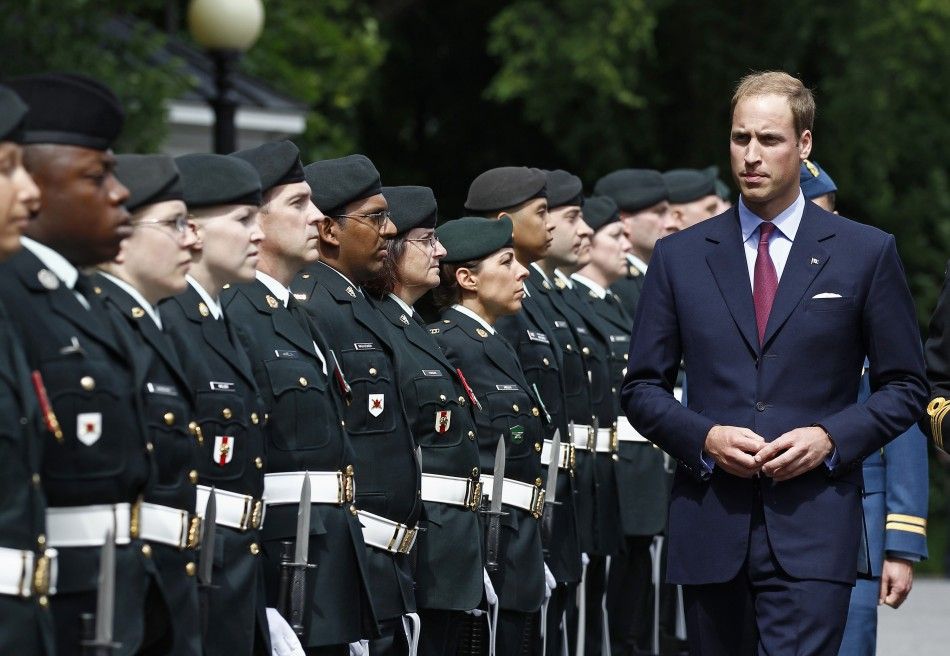  Britains Prince William inspects the honour guard at Rideau Hall in Ottawa