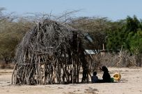 Children affected by the worsening drought due to failed rain seasons, sit outside their makeshift shelter at Sopel village in Turkana