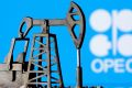 A 3D-printed oil pump jack in front of the OPEC logo in this illustration picture