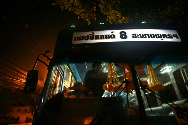 Driver Aphisak starts his shift at 4:00 am, clambering aboard with partner and bus conductor Arunee On-sawats and -- on the day AFP accompanied them -- their two boys