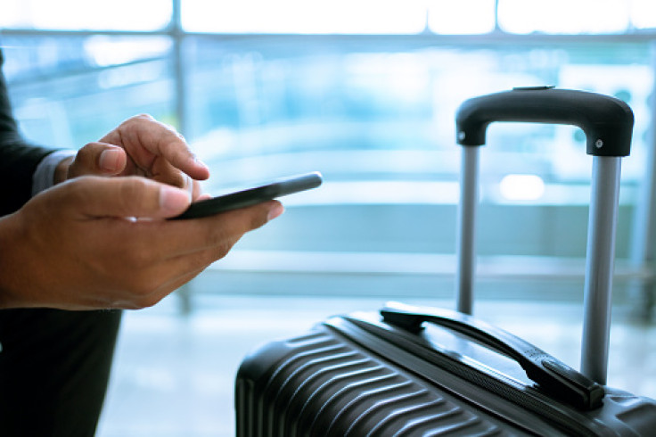 Person using phone at the airport