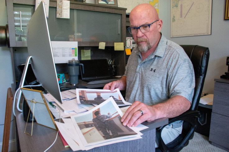 Captain David Ledoux shows printout photos of Indonesian navy onboard his ship Reliance, in New Bern