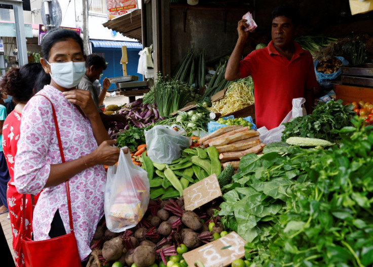 A vendor sells vegetables to a customer amid the rampant food inflation, amid Sri Lanka's economic crisis, in Colombo