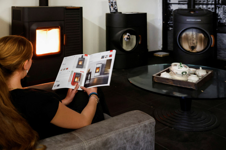 A woman looks at a brochure about pellet stoves, in Wormer