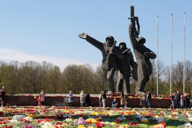 People put flowers next to the Soviet WWII victory monument in Riga