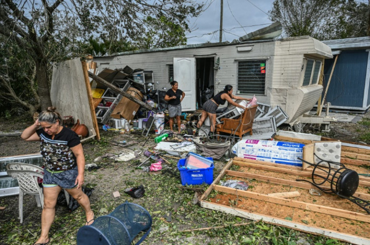 Residents of mobile homes clean up debris in the aftermath of Hurricane Ian, in Fort Myers, Florida, on September 29, 2022