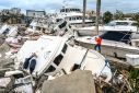 Fox Weather Correspondent Robert Ray takes photos of boats damaged by Hurricane Ian in Fort Myers, Florida, on September 29, 2022