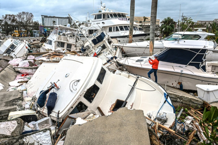 Fox Weather Correspondent Robert Ray takes photos of boats damaged by Hurricane Ian in Fort Myers, Florida, on September 29, 2022