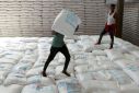 Labourers offload bags of grains as part of relief food that was sent from Ukraine at the WFP warehouse in Adama town.
