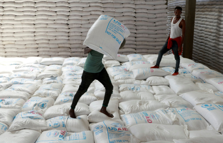 Labourers offload bags of grains as part of relief food that was sent from Ukraine at the WFP warehouse in Adama town.