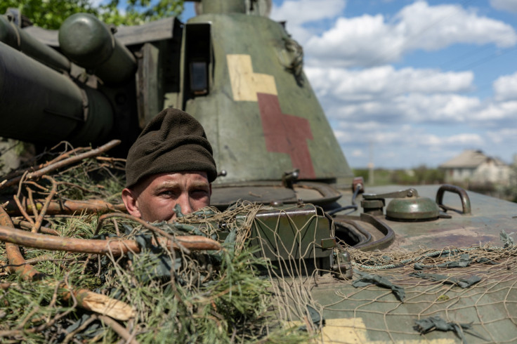 An Ukrainian soldier looks out from a tank, amid Russia's invasion of Ukraine, in the frontline city of Lyman, Donetsk region