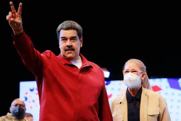 Venezuelan President Nicolas Maduro gestures next to First Lady Cilia Flores whose two nephews were released in a prisoner swap with the United States, in a handout photo from the Venezuelan Presidency