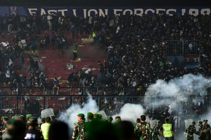 At least 127 people died at a football stadium in Indonesia when fans invaded the pitch and police responded with tear gas