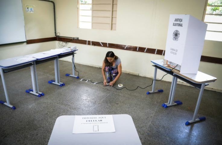 A staffer connects the electronic ballot box at a polling station on the eve of the presidential election in Brasilia on October 1, 2022.