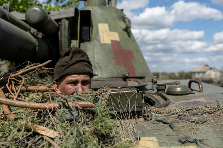 A Ukrainian soldier looks out from a tank, amid Russia's invasion of Ukraine, in the frontline city of Lyman, Donetsk region