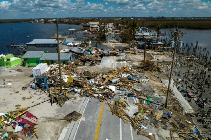 An aerial picture taken on October 1, 2022 shows a broken section of the Pine Island Road, debris and destroyed houses in the aftermath of Hurricane Ian in Matlacha, Florida on October 1, 2022