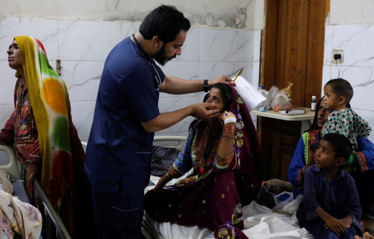 Girl, suffering from malaria and fever, receives medical assistance at Sayed Abdullah Shah Institute of Medical Sciences in Sehwan