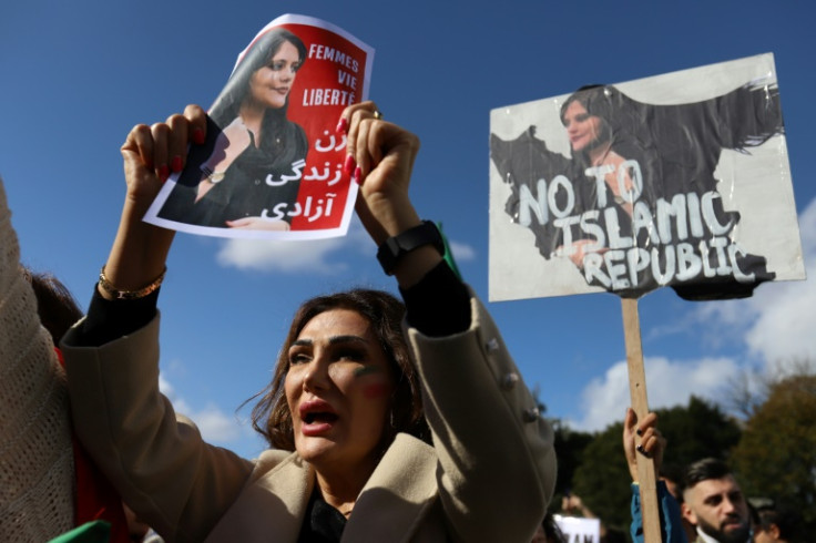 A protestor holds a portrait of Mahsa Amini during a demonstration in Brussels on October 1, 2022